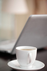 Cup of tea against a laptop