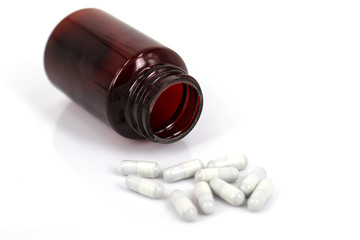 Pills spilling out of pill bottle