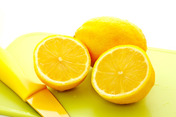 cut lemon with knife on white background