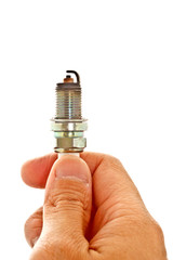 hand holding used spark plug on white background