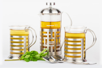Teapot and cups with mint