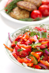 Mixed salad with meatballs on background