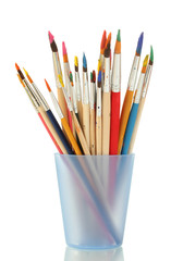 Paint brushes with gouache in cup isolated on white