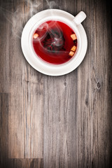 Top view of fruit tea on wooden plank table