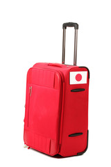 red suitcase with sticker with flag of Japan isolated on white
