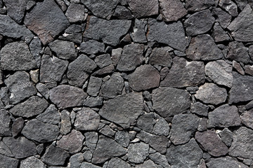 Black lava stone volcanic masonry wall