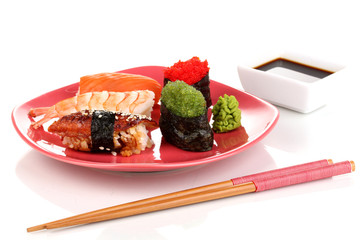 delicious sushi served on red plate isolated on white