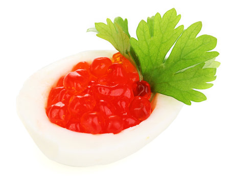 Red caviar in egg isolated on white