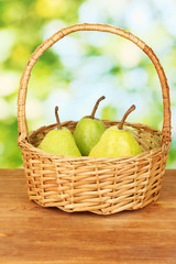 Ripe pears on colorful green background
