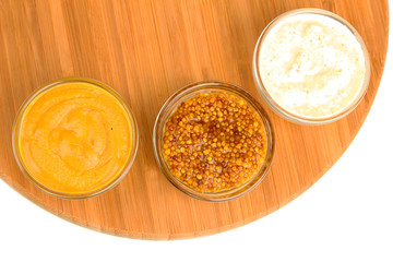 various sauces on chopping board isolated on white