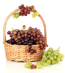 Delicious ripe pink and green grapes in basket isolated on