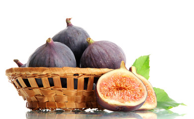 Ripe sweet figs with leaves in basket isolated on white