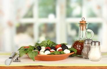 cheese mozzarella with vegetables in the plate with fork and