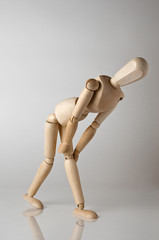 wooden man with knee ache