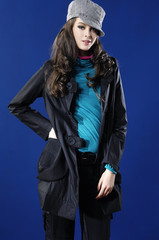 Fashion photo, a model is posing over blue \background