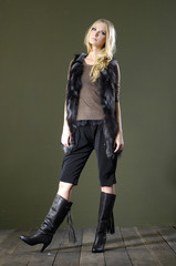 Full length portrait of pretty young woman in hat posing