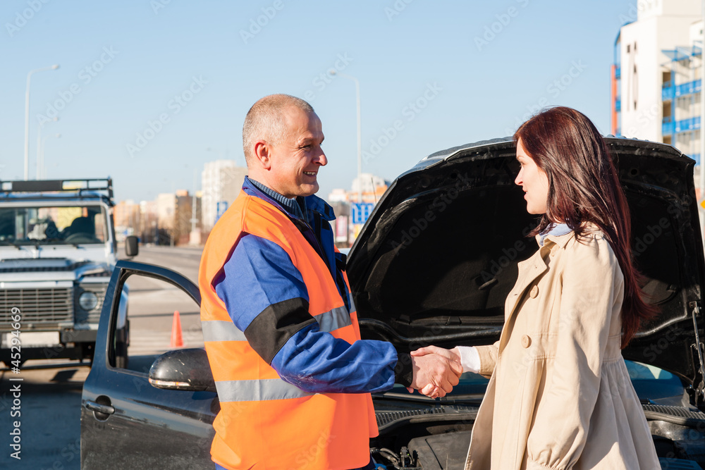 Wall mural woman greeting mechanic after her car breakdown