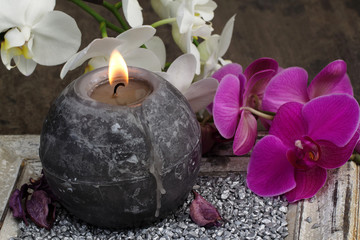Orchideenblüten mit Kerze