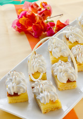 Square mini sponge cakes with merengue