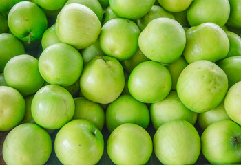 close-up of raw green apple heap in the market