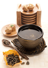 Obraz na płótnie Canvas Asian tea set with dried green tea
