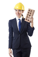 Woman builder with brick on white