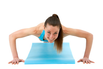 Young fit woman doing push ups.