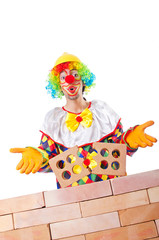 Bad construction concept with clown laying bricks