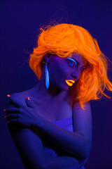 Uv light portrait, woman with glowing accessories and make up - 45310226