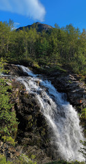 Waterfall on Risjok river and Kuelporr Mount in Khibiny Mountain