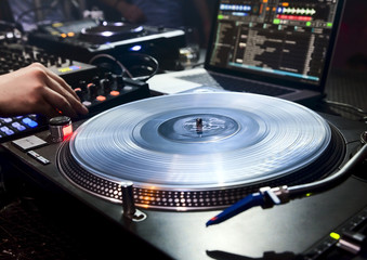 DJ plays set in vinyl player