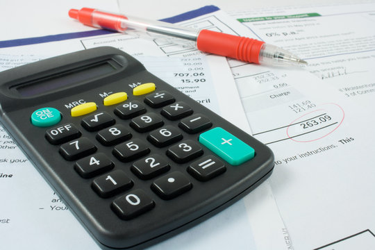 calculator,pen, and bills