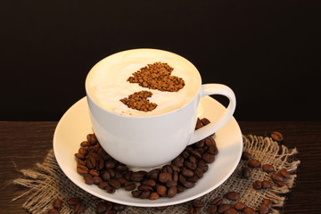 Latte on wooden table on brown background
