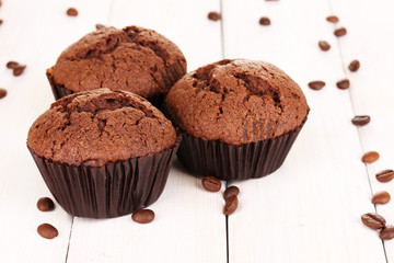 Fresh muffins on wooden background