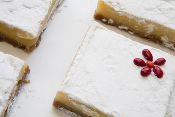 Angled Lemon Bars with Red Flower Accent on Tray