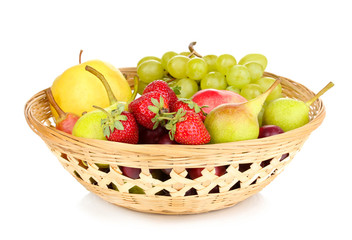 Mix of ripe sweet fruits and berries in basket isolated on