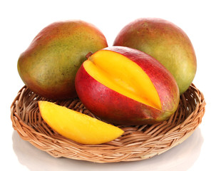 Ripe appetizing mango on wicker cradle isolated on white