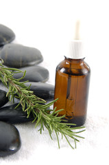 Obraz na płótnie Canvas aroma therapy- rosemary, essential oil and stones