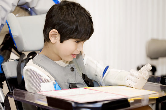 Five year old disabled boy studying in wheelchair