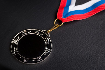 Fototapeta na wymiar Metal medal with tricolor ribbon