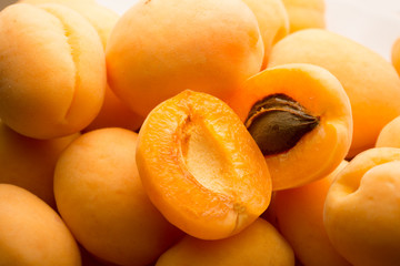 Ripe apricots on white background