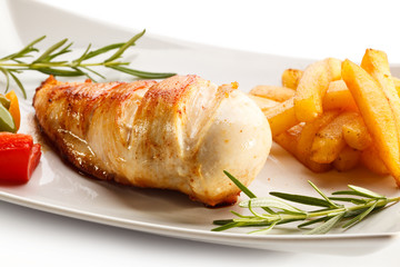 Grilled chicken breast, French fries and vegetables