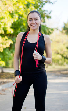 Happy healthy woman with skipping rope
