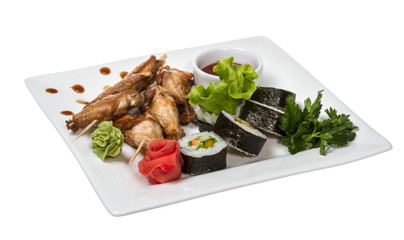 Buffalo chicken wings on plate with sushi