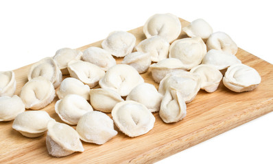 Fototapeta na wymiar Some raw dumplings on the wooden board