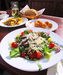 Colorful dishes of meat,cheese and vegetables