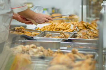 Fried grill chicken wings and legs on table in supermarket. Cook
