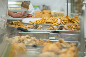 Fried grill chicken wings and legs on table in supermarket. Cook