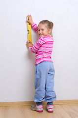 Little girl with measuring level