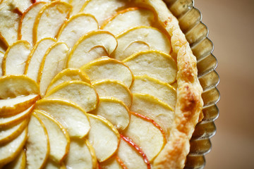 Apple pie or tart in a tin with nice pattern of slices